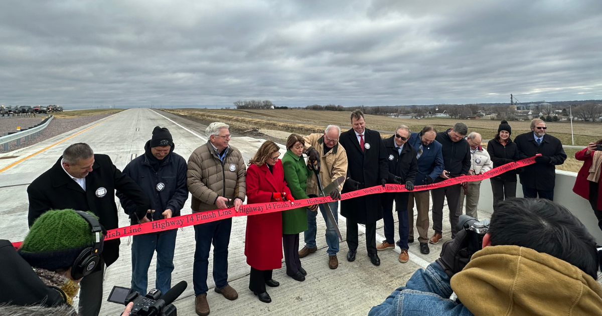 This is a photo of the governor of Wisconsin Tony Evers cutting a ribbon at Courtland Wisconsin on a road construction site built by husband construction company