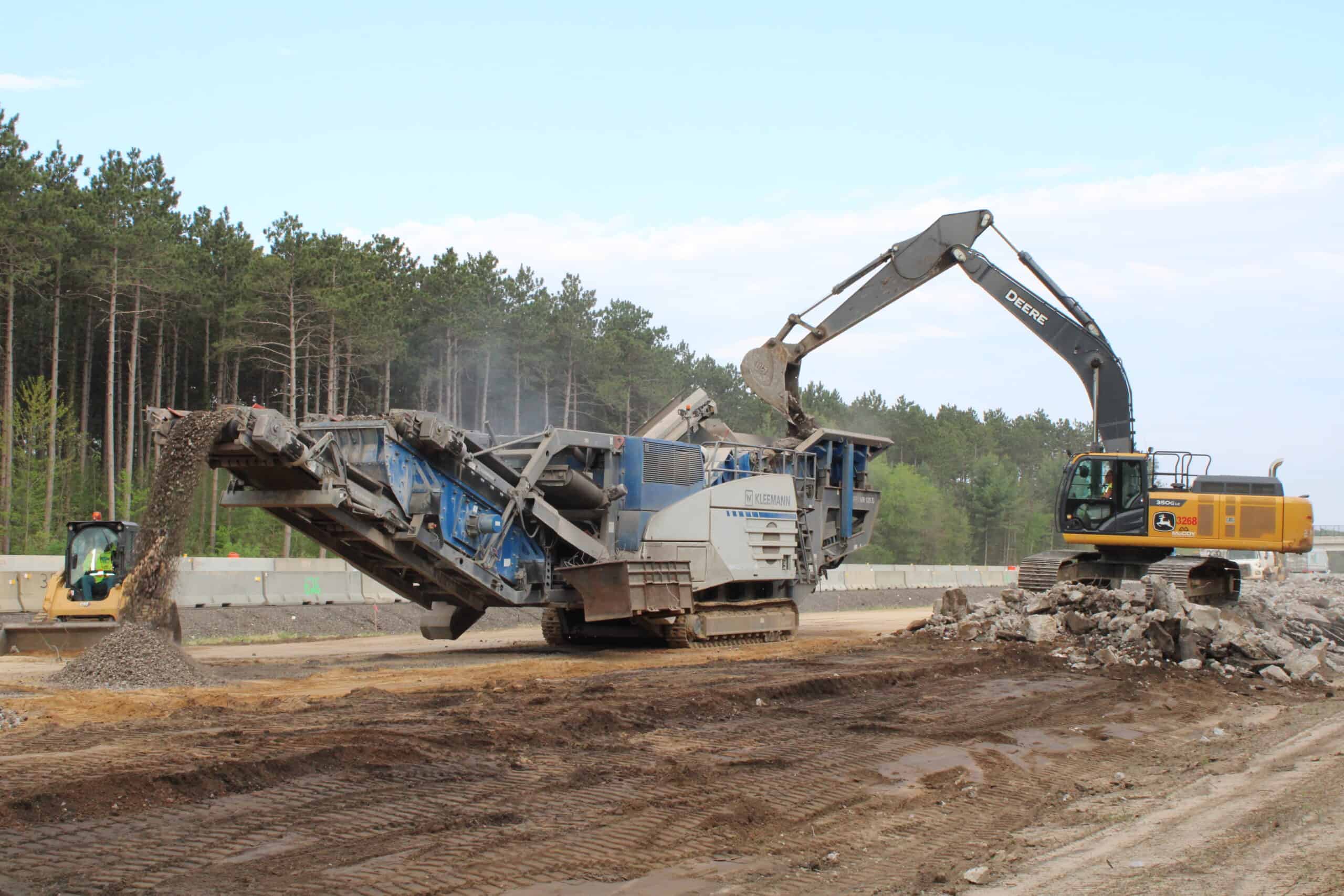 Heavy construction equipment grading a highway.