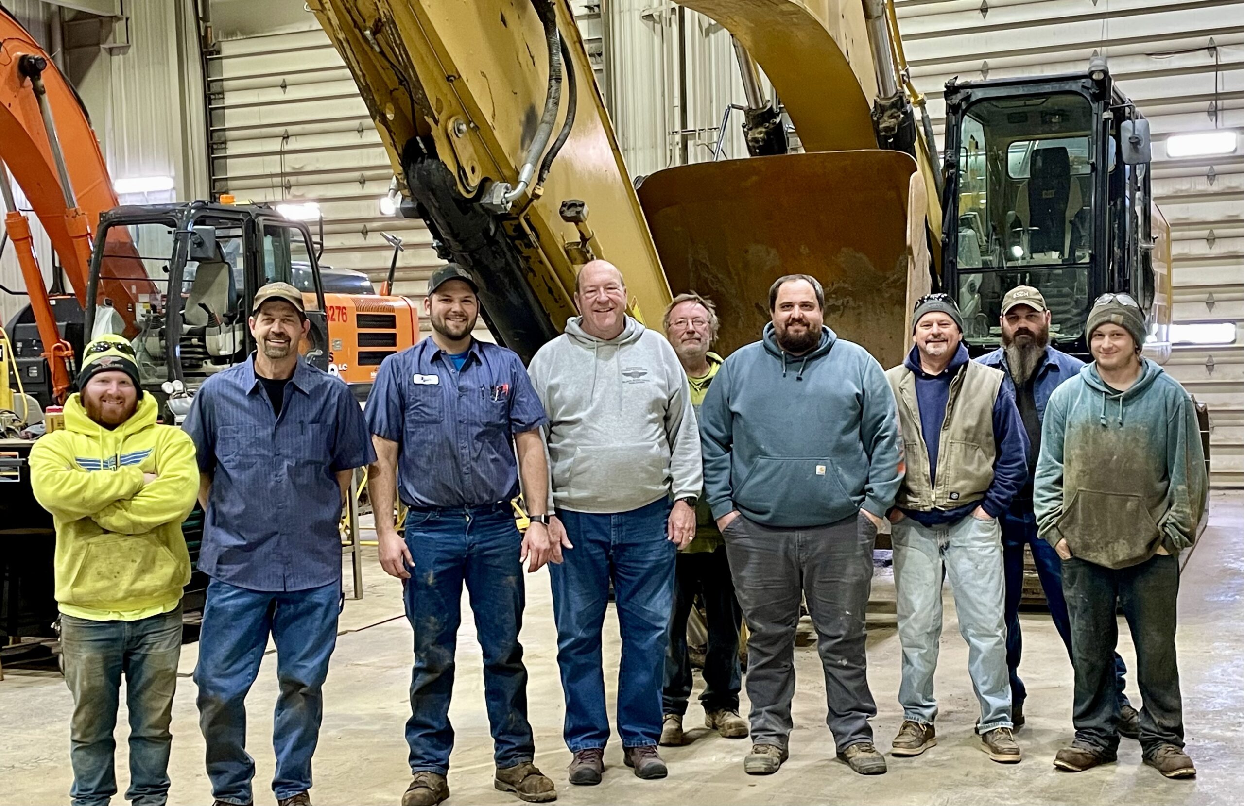 A photo of the Hoffman Construction Company technician crew in the Hoffman Construction Company shop
