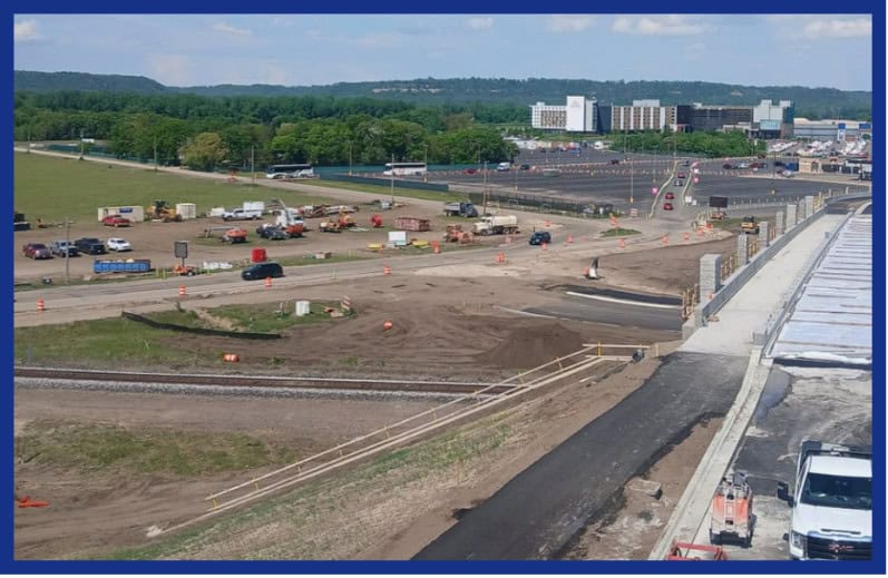 MAY 2025 Newsletter (Real Estate Flyer)-5 road and trucks