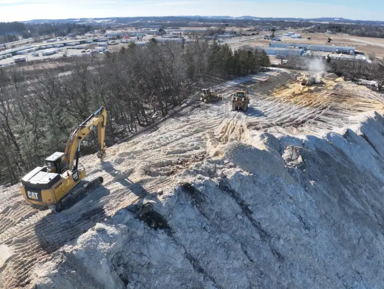 Tomah, Wisconsin construction project viewed from the air, showing excavator on a ridge 